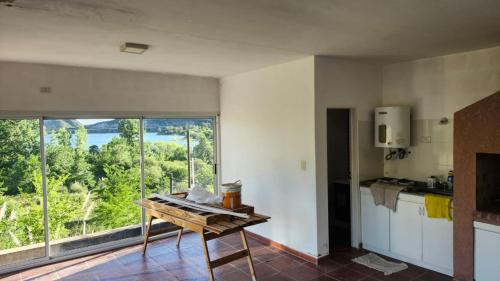a kitchen with a table and a large window at La Colina - Potrero de los Funes in Potrero de los Funes