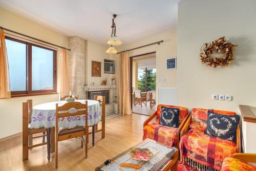 a living room with a table and a couch at Villa Kleino - 30 min from Meteora in Kalabaka