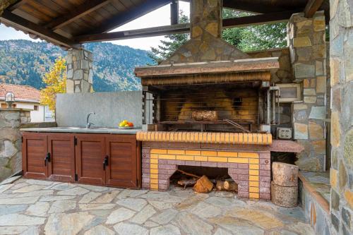 a kitchen with an outdoor oven in a patio at Villa Kleino - 30 min from Meteora in Kalabaka