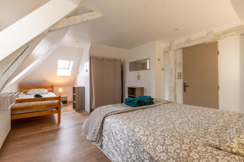 a bedroom with a bed and a dresser at La maison du centre in Vendôme