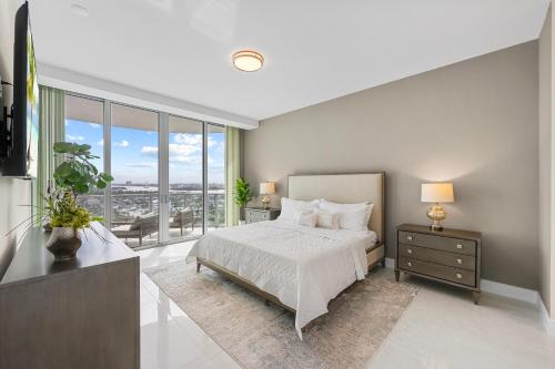 a bedroom with a bed and a large window at 2BR 2BA condo with ocean views in Luxury Resort Amrit in Riviera Beach