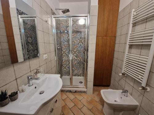 a bathroom with a shower and a sink and a toilet at B&B Casa Ciarpella in Montegranaro