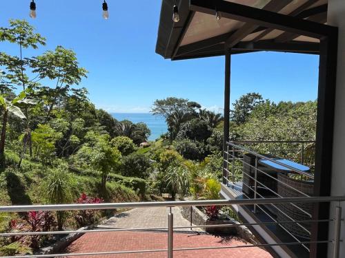 a balcony of a house with a view of the ocean at Casa Ker Lumar in Uvita