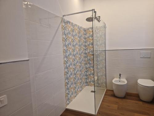 a bathroom with a glass shower and a toilet at B&B Casa Ciarpella in Montegranaro