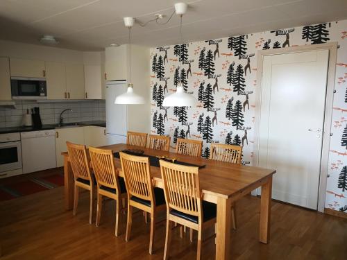a dining room with a wooden table and chairs at Bästa läget i Grönklitt! in Orsa