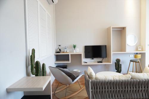 a living room with a couch and a tv at 阿爾法民宿AlphaVilla in Hengchun