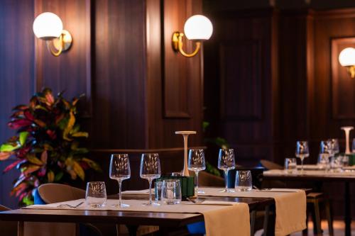 a row of tables in a restaurant with wine glasses at Hotel Simona Halep - Poiana Brasov in Poiana Brasov