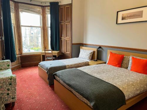 a hotel room with two beds and a window at Airdenair Guest House in Edinburgh