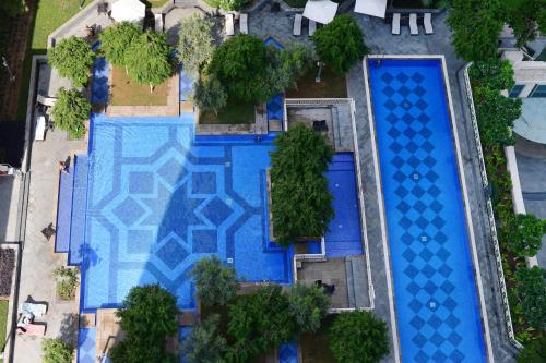 an overhead view of a swimming pool with blue tiles at Burj Khalifa Fireworks View Downtown - One Bedroom Apartment in Dubai