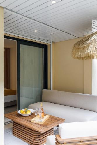 a living room with a couch and a table at Côté Croisette LUXE - 2BdR 2 bthR 2 toilets -Terrace, AC, parking & lift in Cannes