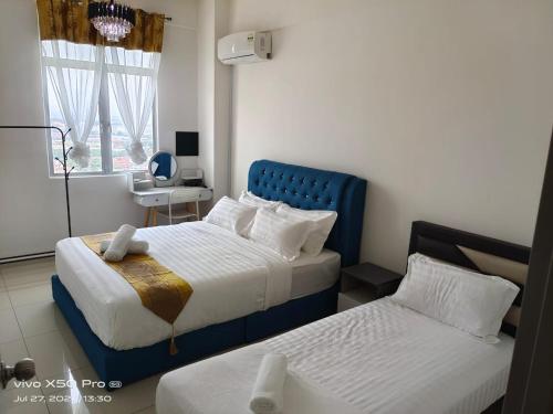 Postel nebo postele na pokoji v ubytování Residensi Meru Raya