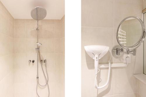 a bathroom with a shower and a mirror at Côté Croisette LUXE - 2BdR 2 bthR 2 toilets -Terrace, AC, parking & lift in Cannes
