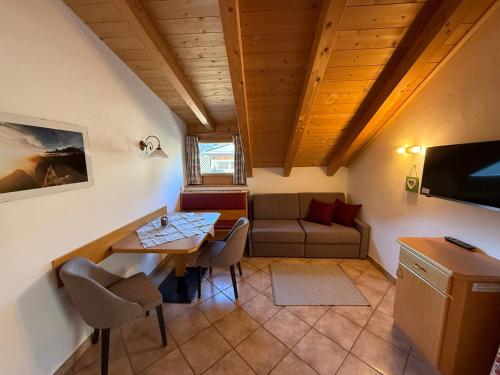 a living room with a couch and a table at Chalet Romy AP 3 in Pramauron