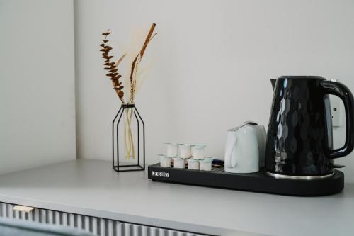 a vase with a plant in it on a kitchen counter at WNS Skylines Village in London