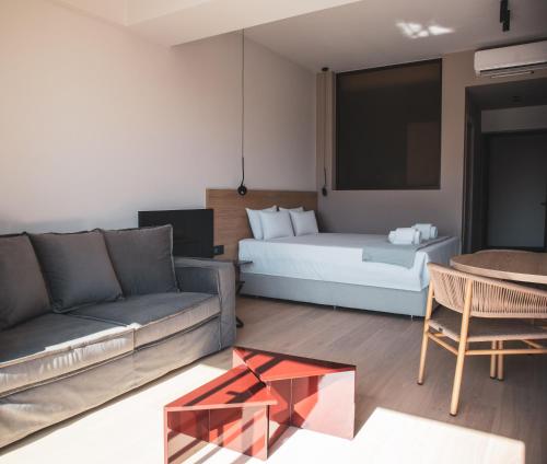 a living room with a bed and a couch and a table at Alinea Lano Old Town Center in Limassol