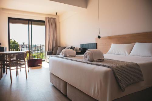a bedroom with a large bed and a living room at Alinea Lano Old Town Center in Limassol