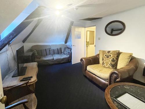 a living room with a couch and a table at The Crown, Smallburgh in Smallburgh