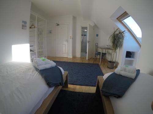 a bedroom with two beds and a table in it at Seagull Cottage B&B in Portmagee