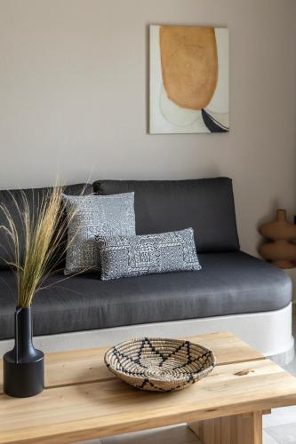 a living room with a couch and a table at Fari Stone Villas in Skala Marion