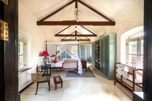 a bedroom with a bed and a chandelier at The Sun House in Galle