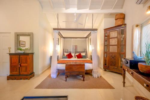 a bedroom with a bed with red pillows at The Sun House in Galle