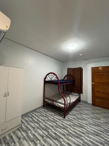 an empty room with a bunk bed in a room at Cozy Stay Near Bacnotan Plaza in Bacnotan