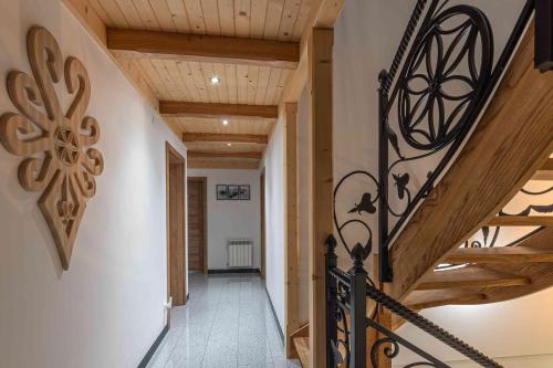 a hallway of a house with a staircase with wooden ceilings at Goralove Pole in Brzegi