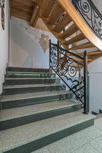 a set of stairs with a wrought iron railing at Goralove Pole in Brzegi