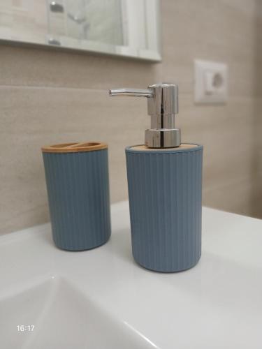 a bathroom sink with a faucet and two trash cans at La Casa nella Contea in Terni