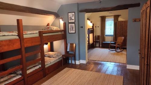 a room with two bunk beds and a hallway at La Maison Vienvenue - Bike, hike and meet alike in Anthisnes