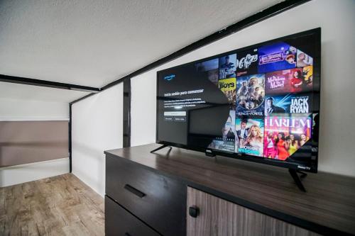 a flat screen tv on a stand in a room at Lofts Tequisquiapan in San Luis Potosí