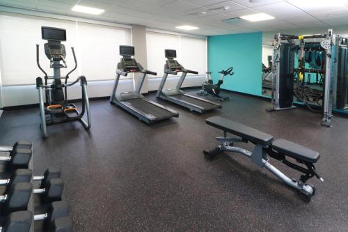 a gym with several tread machines in a room at Avid Hotel Querétaro Centro Sur by IHG in Querétaro