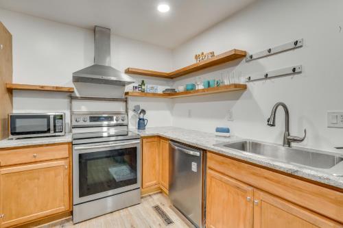 a kitchen with a sink and a stove at Chic Farmhouse, 3Mi to Lake-Pet Friendly and Golfing in Eureka Springs