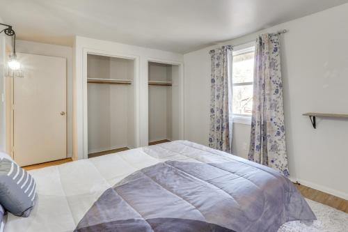 a bedroom with a large bed and a window at Chic Farmhouse, 3Mi to Lake-Pet Friendly and Golfing in Eureka Springs
