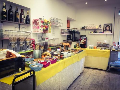 a kitchen with a yellow counter with food on it at Hotel Villa Enea in Cattolica