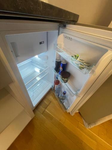 an empty refrigerator with its door open in a kitchen at Victoriei light studio in Bucharest