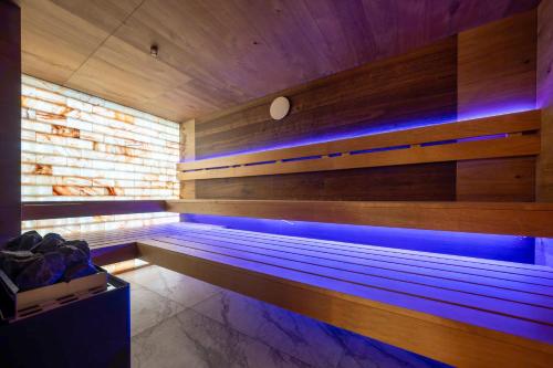 a sauna with blue lights in a wooden wall at Hotel Simona Halep - Poiana Brasov in Poiana Brasov