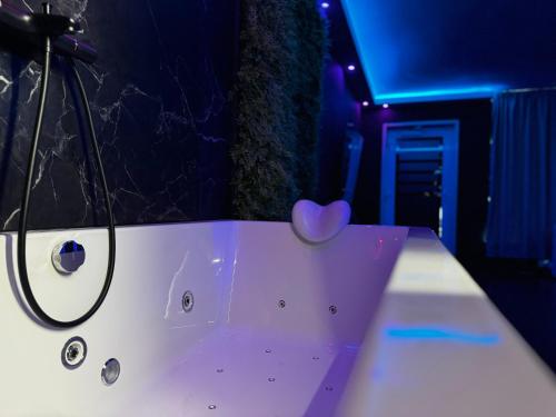 a bath tub with a heart on the side of it at Spartementen by Pure-Zen in Rotterdam