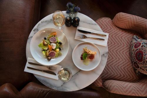a table with two plates of food on it at The River Lee Hotel a member of The Doyle Collection in Cork