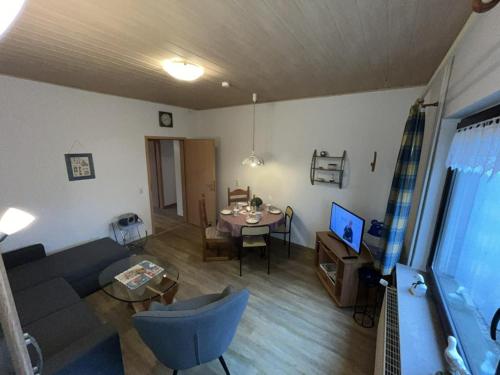 a living room with a couch and a table at !!!NEU!!! Ferienwohnung an der Harle EG in Carolinensiel
