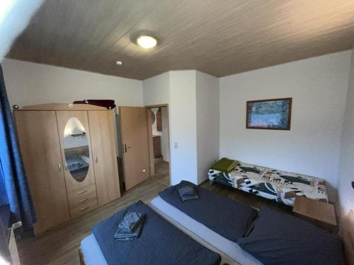 a room with two beds and a cabinet in it at !!!NEU!!! Ferienwohnung an der Harle EG in Carolinensiel