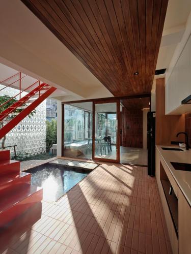 a kitchen with a swimming pool in a house at Sense of Jedyod - near Maya Nimman in Chiang Mai