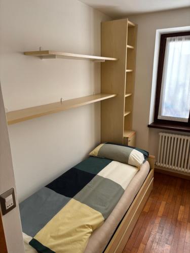 Ένα ή περισσότερα κρεβάτια σε δωμάτιο στο Appartamento Dolomiti