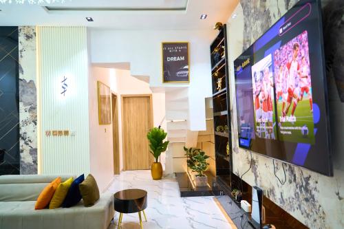 a living room with a large flat screen tv at ABOT Luxury Homes in Lekki