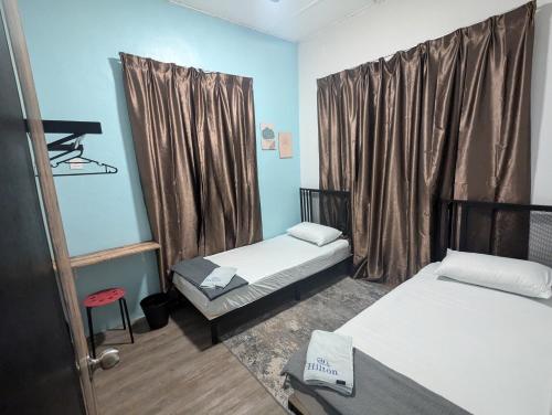 a small room with two beds and a window at Shines GuestHouse 3Br with Outdoor Chilling in Pasir Gudang