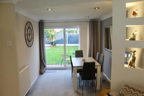 a dining room with a table and a window at Beautiful home near beach in Formby