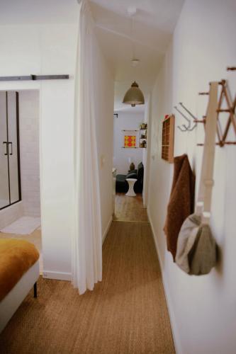 a room with a hallway with white walls and a stairway at Studio Microchole Chinon in Chinon