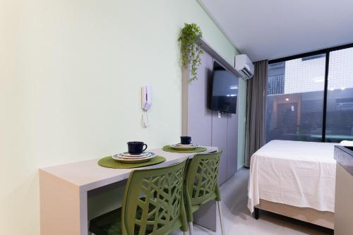 a kitchen with a table with two plates on it at Breeze Residence #111 - Conforto por Carpediem in Tambaú