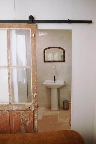 a bathroom with a sink and a mirror at Studio Microchole Chinon in Chinon