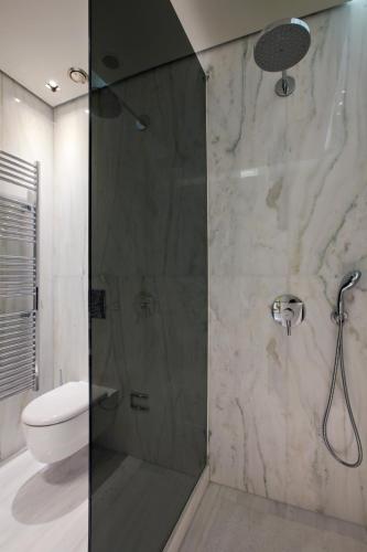 a bathroom with a shower with a toilet and a shower head at MET34 Athens in Athens